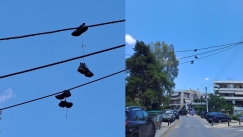 Το «shoefiti» εμφανίστηκε στον Χολαργό: Τι συμβολίζουν τα κρεμασμένα παπούτσια στα σύρματα της ΔΕΗ